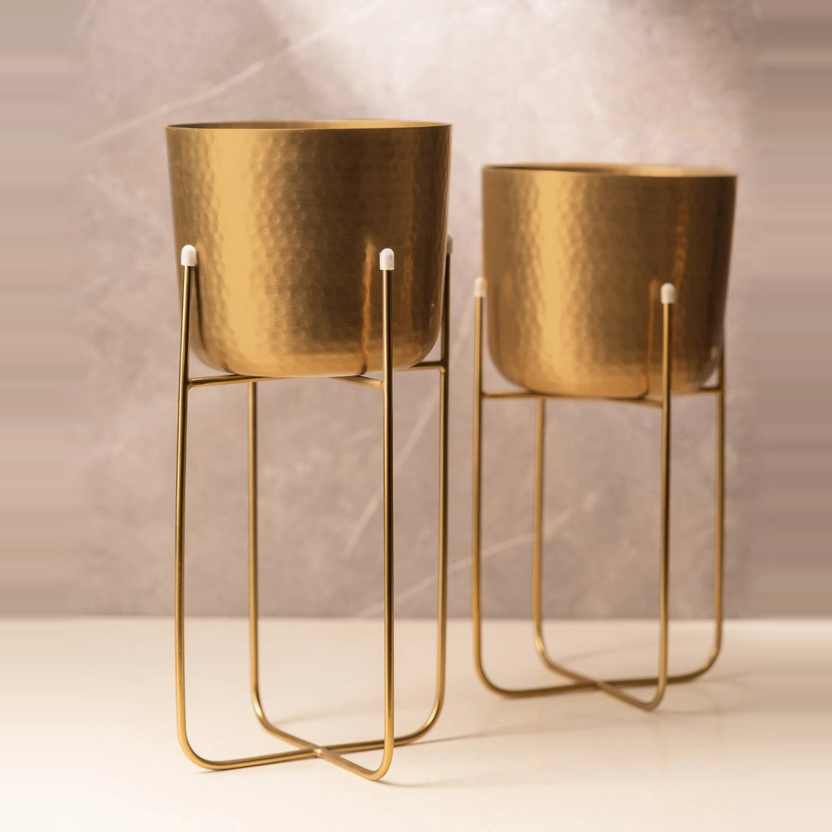 Set of two hammered gold planters on wire stands