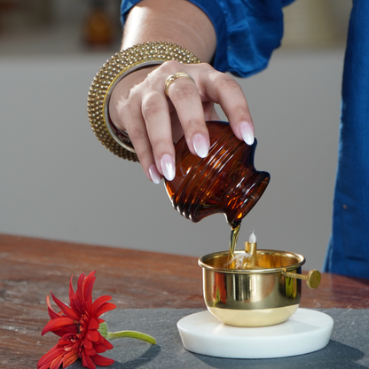 Pouring oil into the brass Akhand Jyot diya