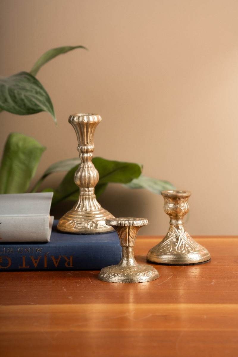 Set of three antique gold embossed candle holders
