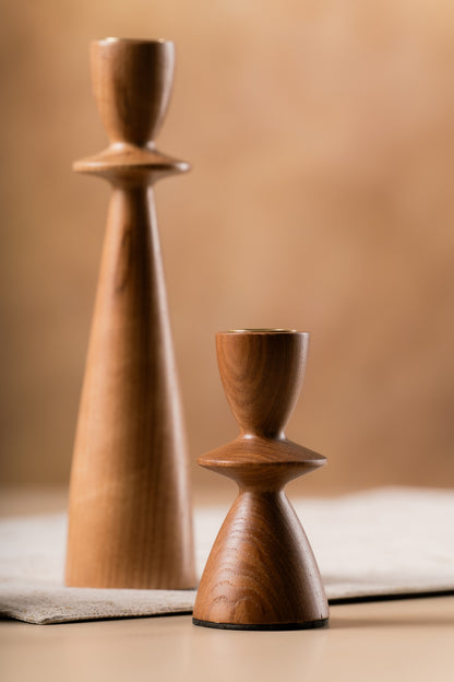 Sculptural wooden candle holders side by side