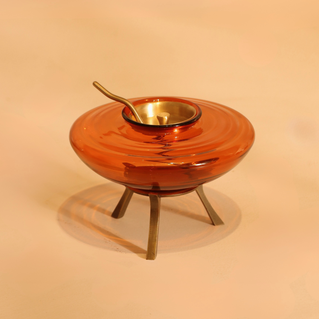 Amber glass ghee dani with brass lid, spoon and warming stand