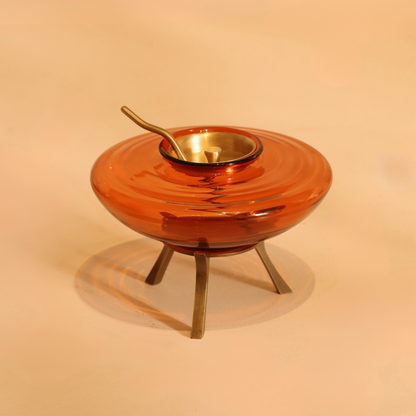 Amber glass ghee dani with brass lid, spoon and warming stand