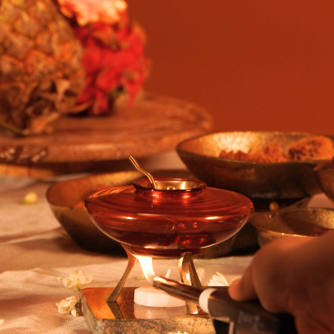 Lighting the tealight under the ghee warmer on a festive table