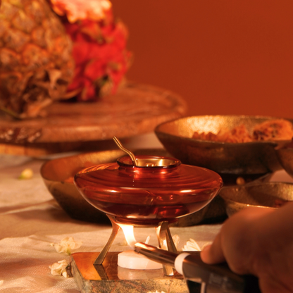 Lighting the tealight under the ghee warmer on a festive table