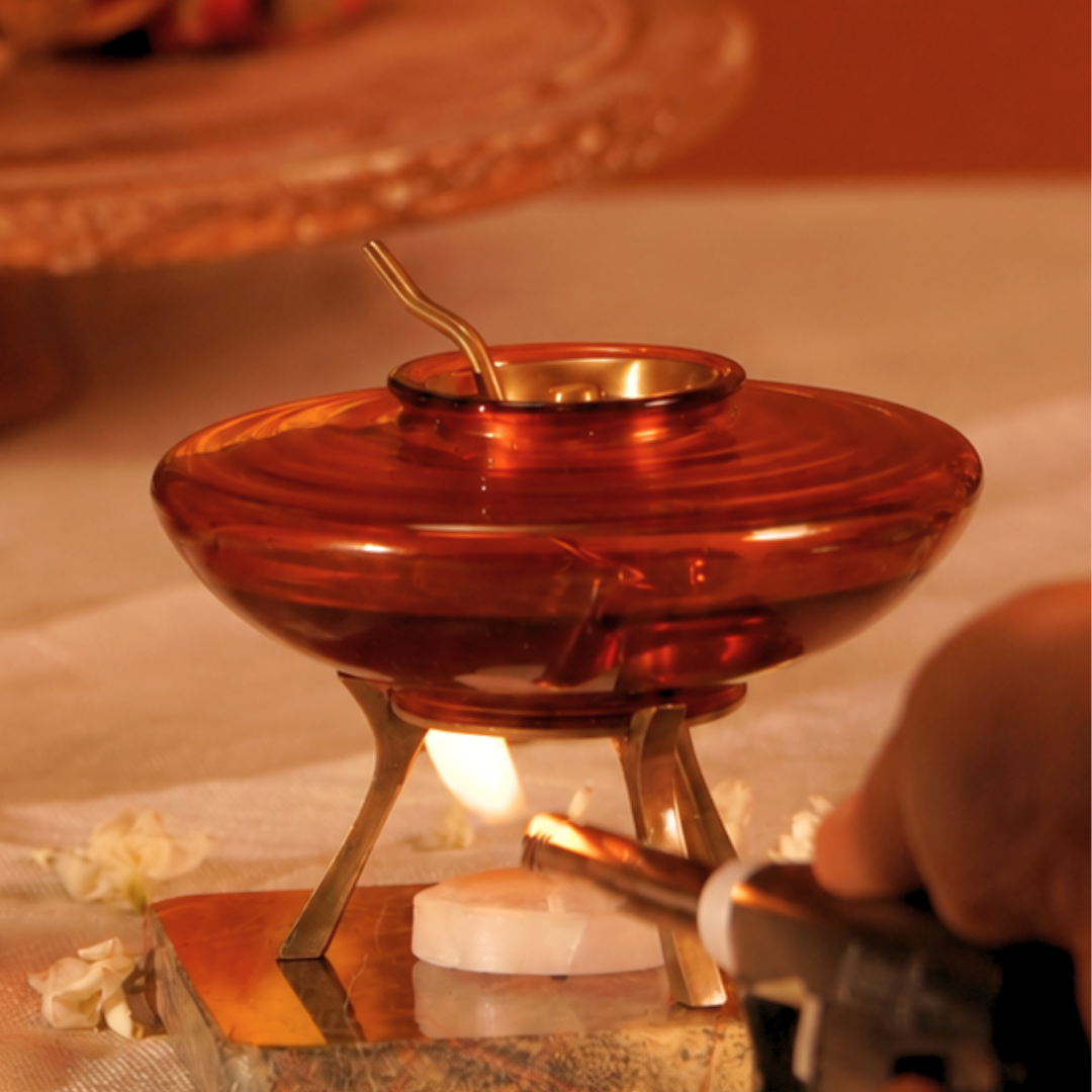 Ghee pot on its stand with a lit tealight