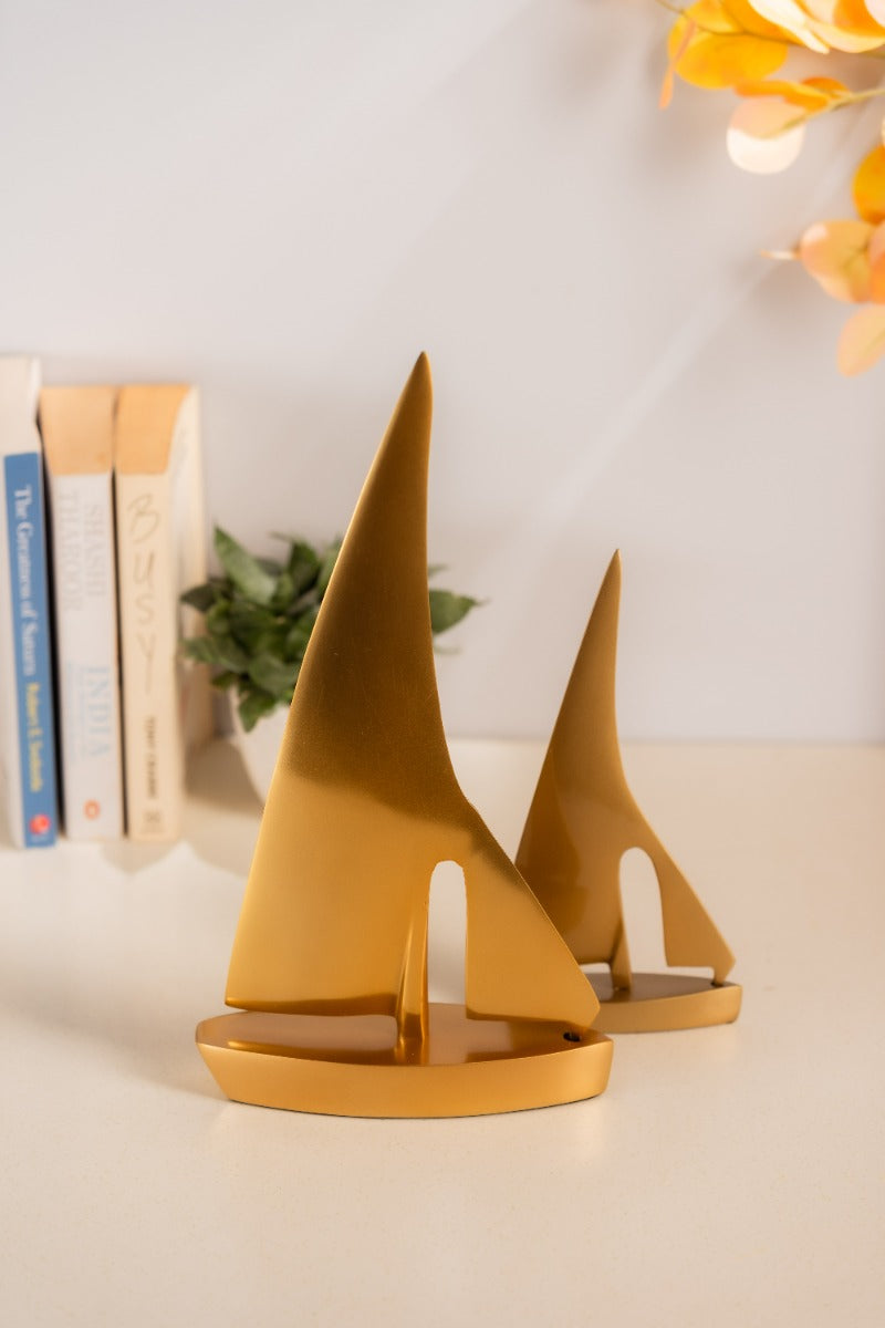 Large and small golden sail boats