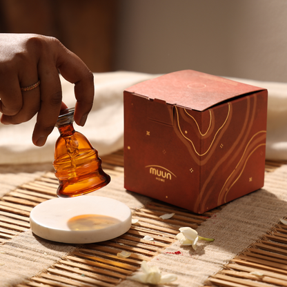 Lifting the amber glass bell beside its gift box