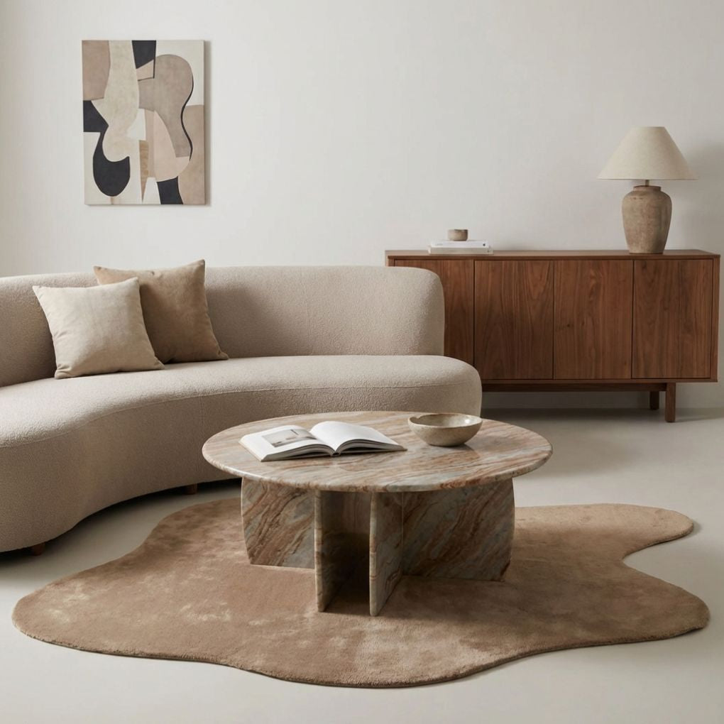 Abstract Rug in Clay styled with Raio Marble Coffee Table. Organic shaped bamboo silk rug in warm beige tones on a microcement floor.