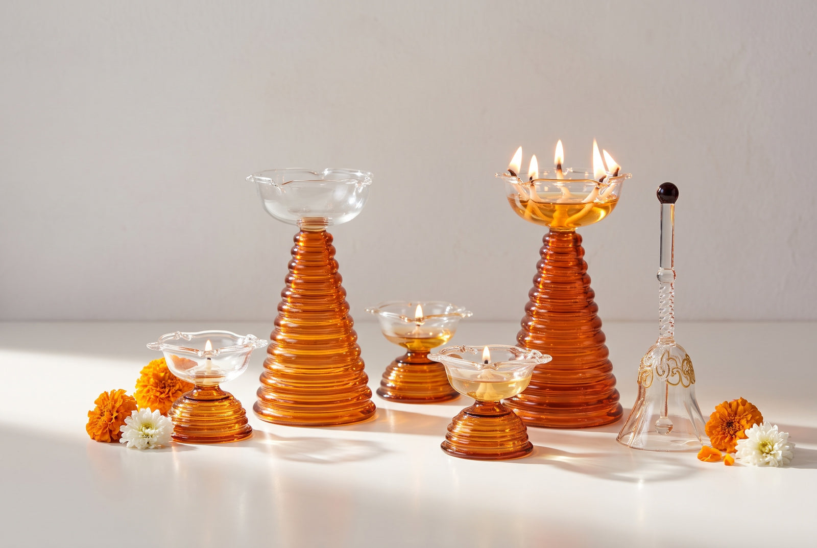 Amber glass diyas with marigolds