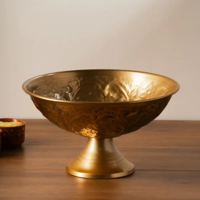 Royal embossed brass bowl on a wooden table