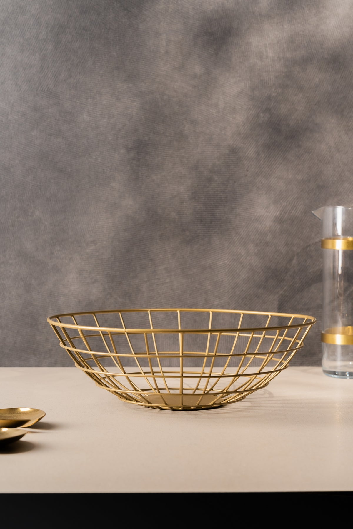 Shallow gold wire basket on a dining table