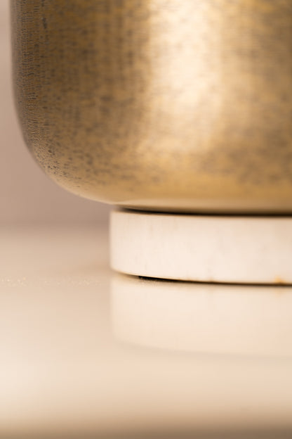 Detail of the hammered finish and white marble base
