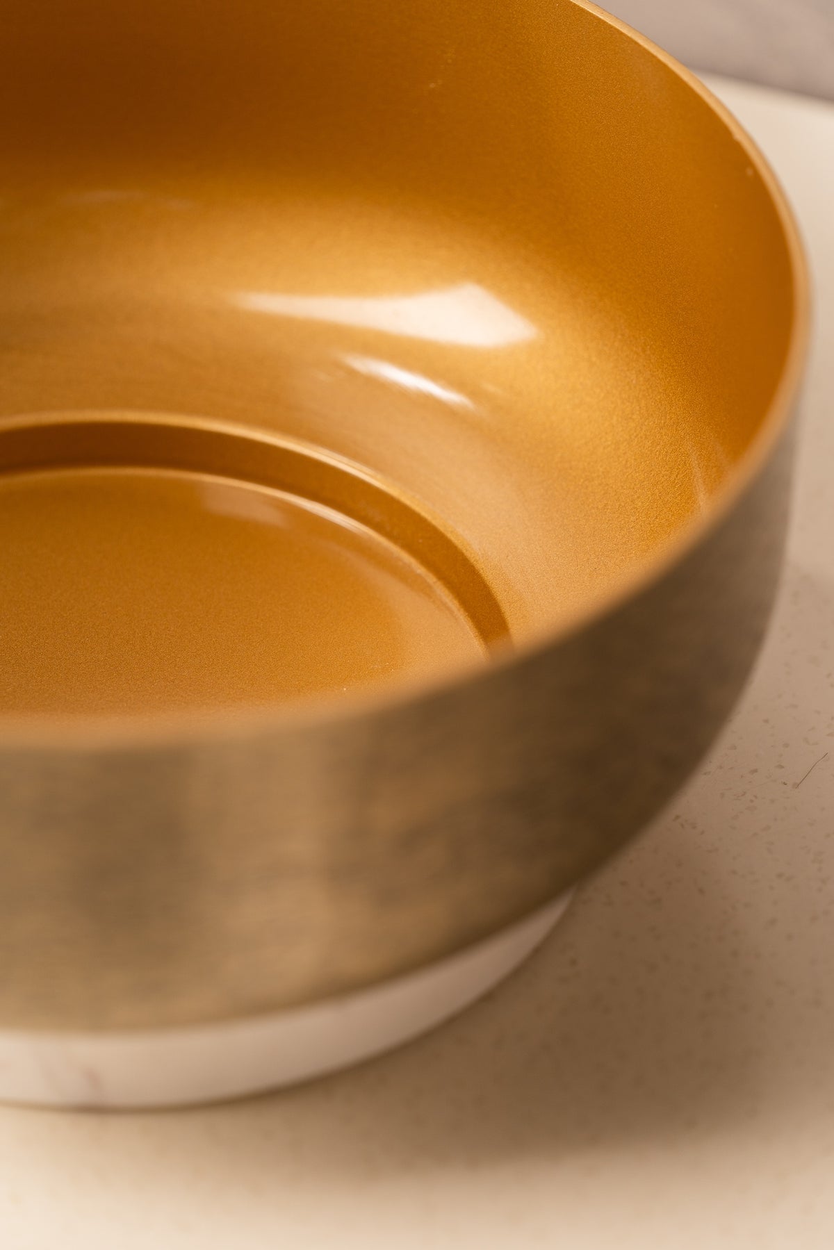 Smooth gold interior of the hammered bowl