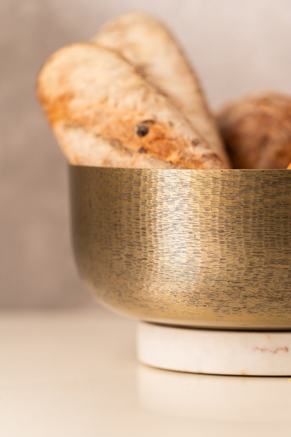 Close-up of the hammered gold texture with bread