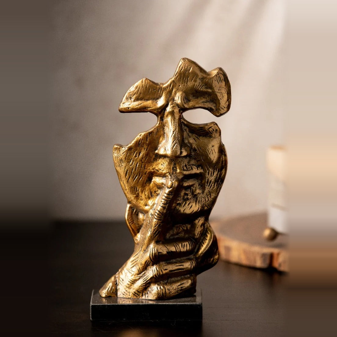 Antique gold Sssh face sculpture on a marble base