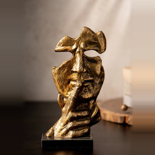 Antique gold Sssh face sculpture on a marble base