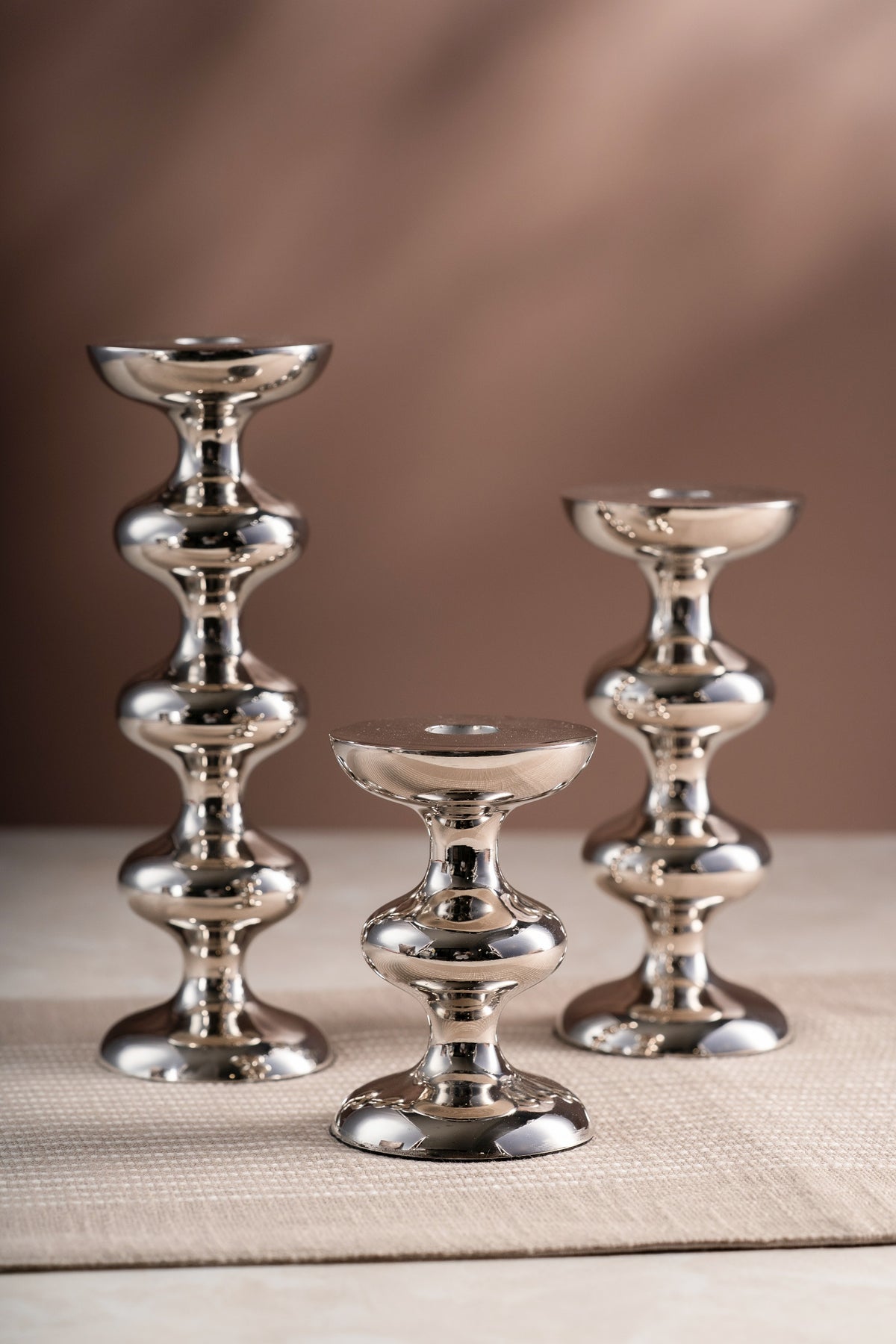 Tiered silver candlesticks in three heights