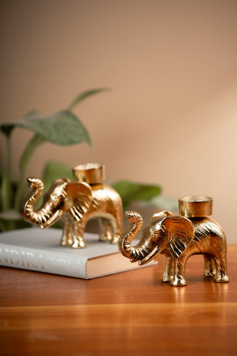 Tusker elephant tealight holders on a wooden table