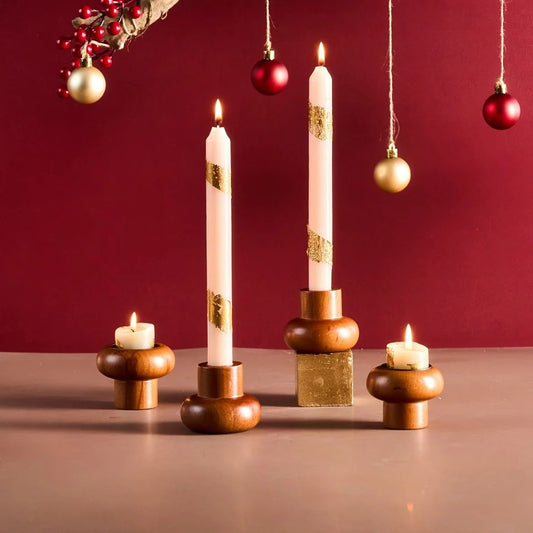 Solid wood candle holders with tapers and tealights on a festive table