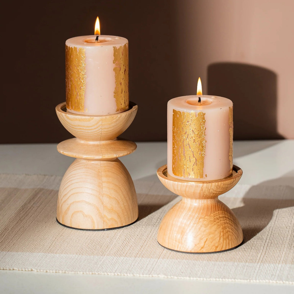 Pair of wooden pillar candle holders in two heights